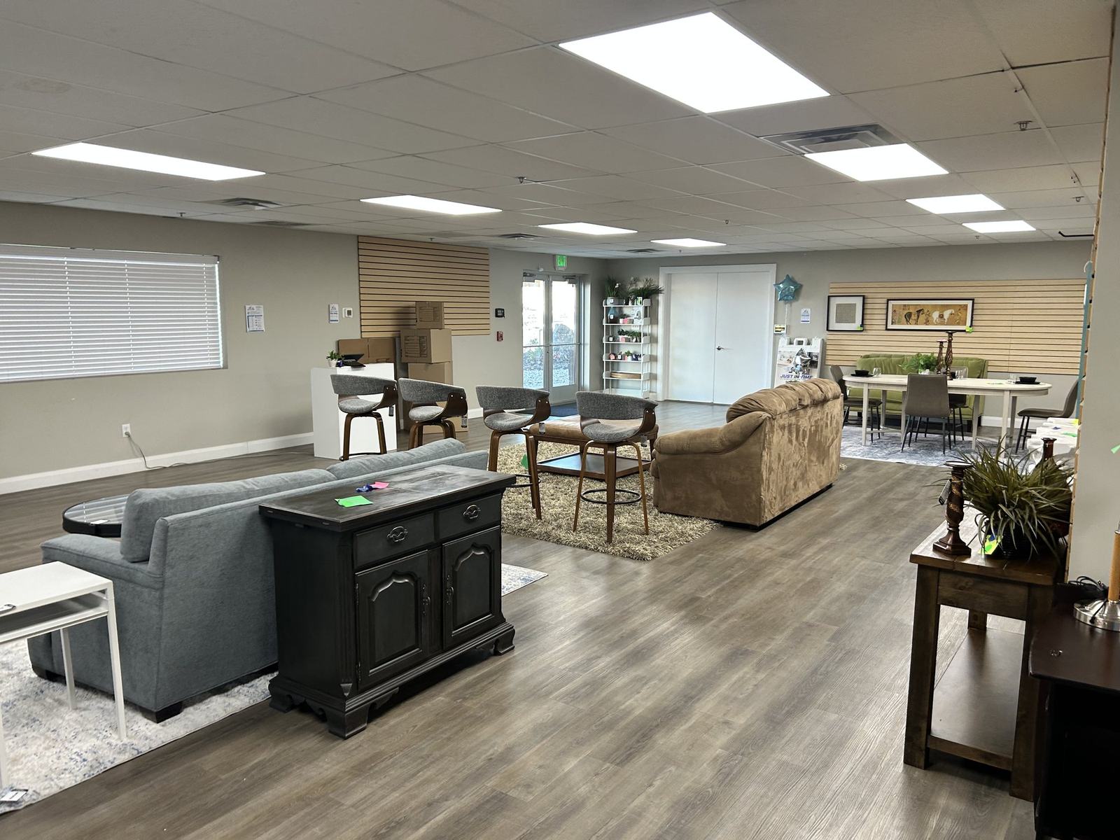 Inside the Just-In Time Consignment showroom in St. George, showing sofas, dining sets and display islands on an open sales floor